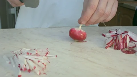 Chefs hands cutting a fresh radish. Video stock 80074350