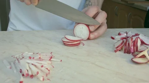 Chefs hands cutting a fresh radish. Video stock 80074352