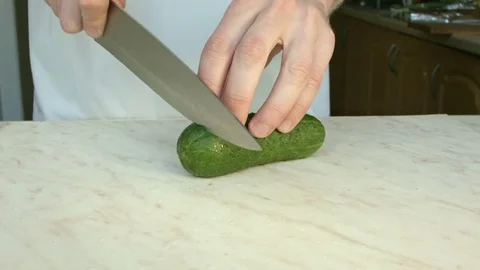 Chefs hands cutting a green fresh cucumber. 스톡 동영상 80238943