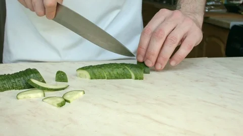 Chefs hands cutting a green fresh cucumber. 스톡 동영상 80441313