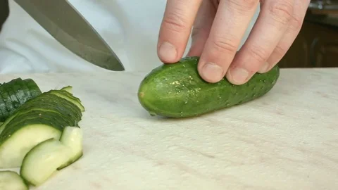 Chefs hands cutting a green fresh cucumber. Vídeo Stock 80441559