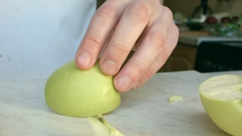 Chefs hands cutting a green fresh apple. Video stock 80460066