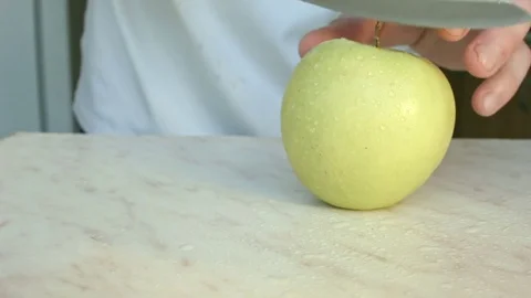 Chefs hands cutting a green fresh apple. Video stock 80460089
