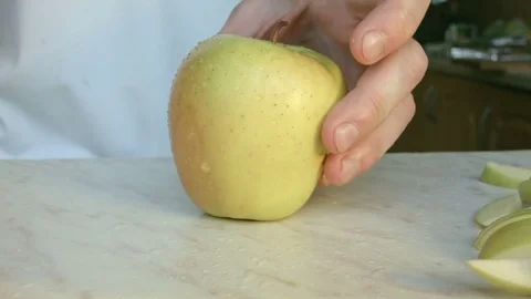 Chefs hands cutting a green fresh apple. Video stock 80461985