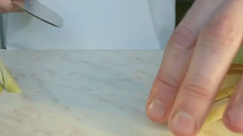 Chefs hands cutting a green fresh apple. Video stock 80462487