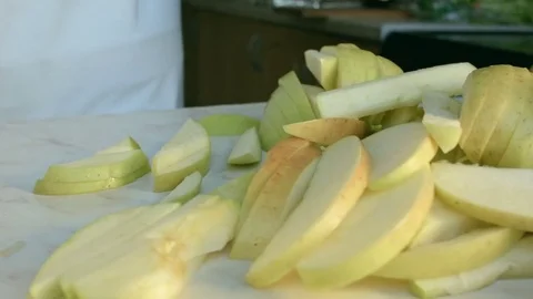 Chefs hands cutting a green fresh apple. Video stock 80462489