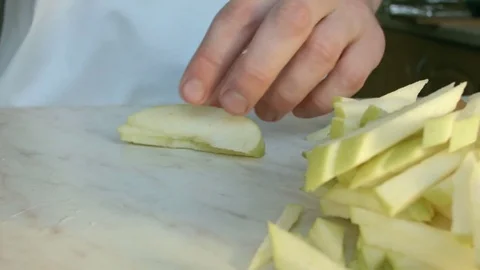 Chefs hands cutting a green fresh apple. Video stock 80463170