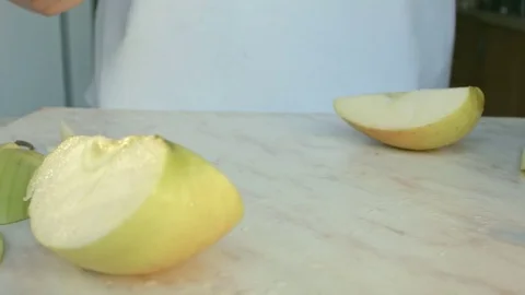 Chefs hands cutting a green fresh apple. Video stock 80471508