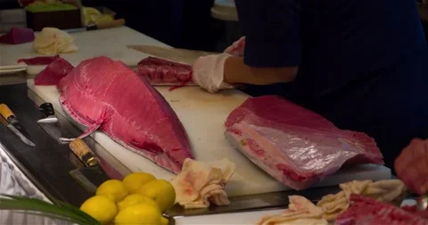 Chefs hands cutting with knife big bluefin tuna fish 4k video sushi restaurant Stock Footage 67487671
