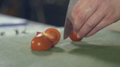 Chef's hands cutting red fresh tomato Stock Footage 70384602