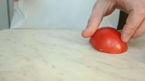 Chefs hands cutting a red fresh tomato. Stock Footage 80441573