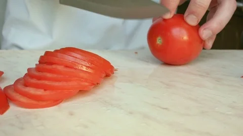 Chefs hands cutting a red fresh tomato. 스톡 동영상 80441701
