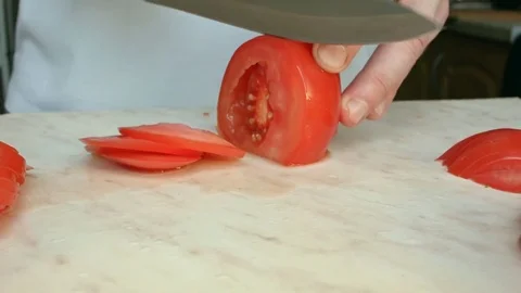 Chefs hands cutting a red fresh tomato. 스톡 동영상 80441707