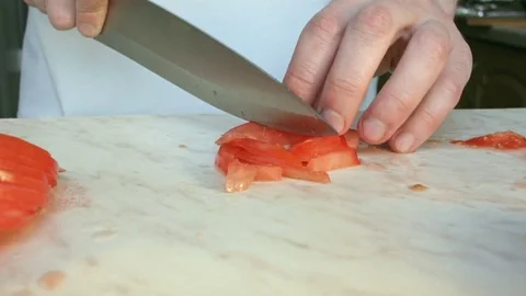 Chefs hands cutting a red fresh tomato. Video stock 80460098