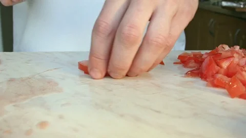 Chefs hands cutting a red fresh tomato. Stock Footage 80460100