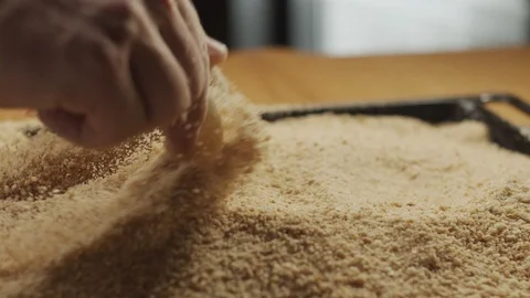 Chef's hands dip fresh shrimp into breadcrumbs on the kitchen table. Slow motion Stock Footage 116163014