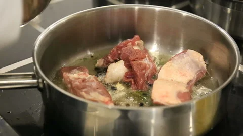 Chef's hands frying meat in a pan Stock Footage 144460414
