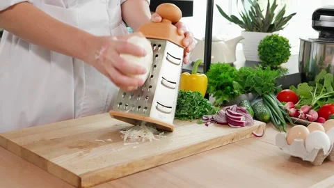 Chef's hands grate mozzarella cheese on a coarse grater Stock Footage 266317768