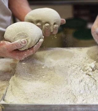Chefs Hands Kneading Fresh Bread Dough on a Floured Worktop Stock Photos