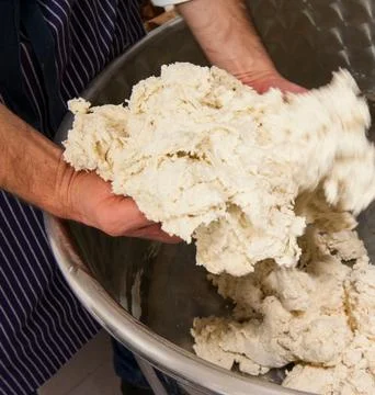 Chefs Hands Kneading Fresh Bread Dough on a Floured Worktop Stock Photos