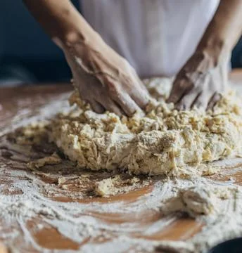 Chefs Hands Kneading Fresh Bread Dough on a Floured Worktop Stock Photos