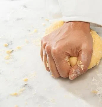 Chefs Hands Kneading Fresh Bread Dough on a Floured Worktop Stock Photos