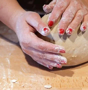 Chefs Hands Kneading Fresh Bread Dough on a Floured Worktop Stock Photos