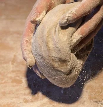 Chefs Hands Kneading Fresh Bread Dough on a Floured Worktop Stock Photos