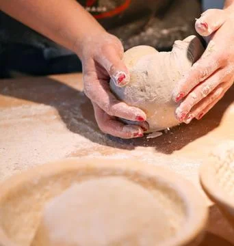 Chefs Hands Kneading Fresh Bread Dough on a Floured Worktop Stock Photos