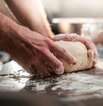 Chefs Hands Kneading Fresh Bread Dough on a Floured Worktop Stock Photos