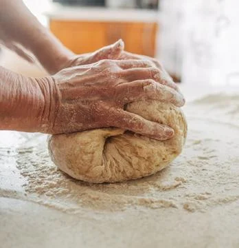 Chefs Hands Kneading Fresh Bread Dough on a Floured Worktop Stock Photos