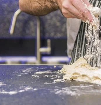 Chefs Hands Kneading Fresh Bread Dough on a Floured Worktop Stock Photos