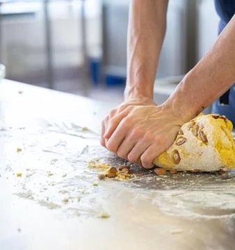 Chefs Hands Kneading Fresh Bread Dough on a Floured Worktop Stock Photos