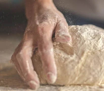 Chefs Hands Kneading Fresh Bread Dough on a Floured Worktop Stock Photos