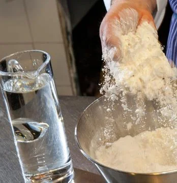 Chefs Hands Kneading Fresh Bread Dough on a Floured Worktop Stock Photos