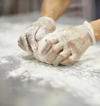 Chefs Hands Kneading Fresh Bread Dough on a Floured Worktop Stock Photos