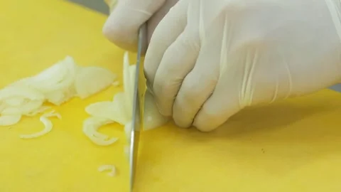 Chef's hands with knife cutting the onion on the board Stock Footage 145963414