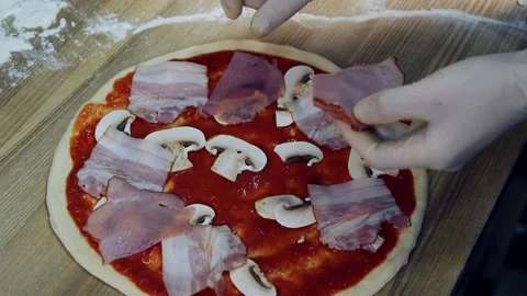 Chef's hands lay out pieces of meat, sausages on a pizza dough blank with tomato 스톡 동영상 318310517