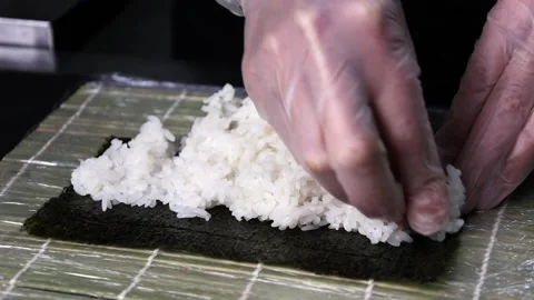 Chef's hands make sushi  slow motion soy rice rolls Stock Footage 168341918