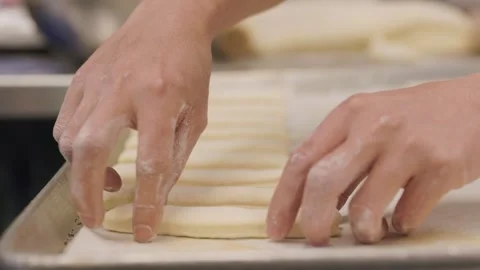 Chefs hands making bread in a bakery, baguette, flour. 4K 24FPS Stock Footage 250948924