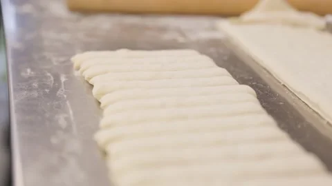Chefs hands making bread in a bakery, baguette, flour. 4K 24FPS Stock Footage 258808015