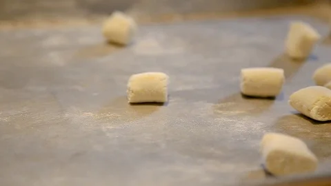 Chefs hands making fresh gnocchi pasta in a restaurant kitchen. Vídeo Stock 96475415