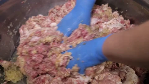 The chef's hands mix pork, bread, minced meat, lard and egg to make meatballs. Video stock 241180553