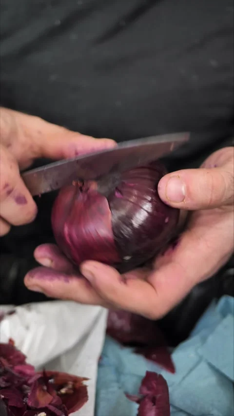 Chef's hands peeling red onions close-up Stock Footage 306882662