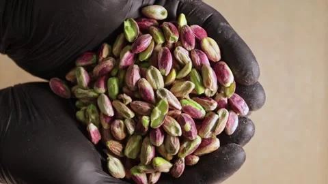 Chef's Hands Pouring Pistachios on Table Stock Footage 247137748