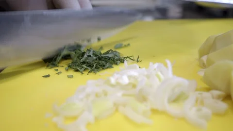 Chef's hands preparing chopped vegetables, garlic, onions, leeks Stock Footage 121793370