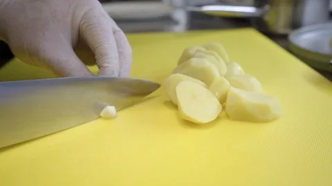 Chef's hands preparing chopped vegetables, garlic, onions, leeks Stock Footage 121793406