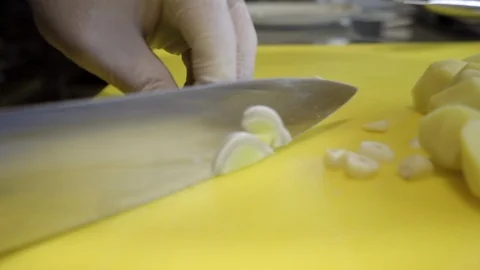 Chef's hands preparing chopped vegetables, garlic, onions, leeks Stock Footage 121793481