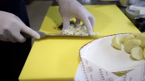 Chef's hands preparing chopped vegetables, garlic, onions, leeks Stock Footage 121793573