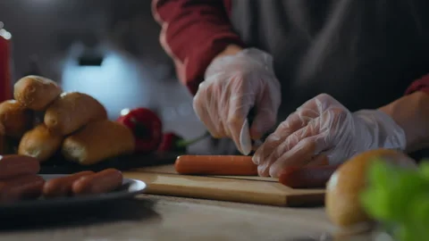 Chef's hands preparing hot dogs. The process of preparing buns with sausage. Stock Footage 279933356